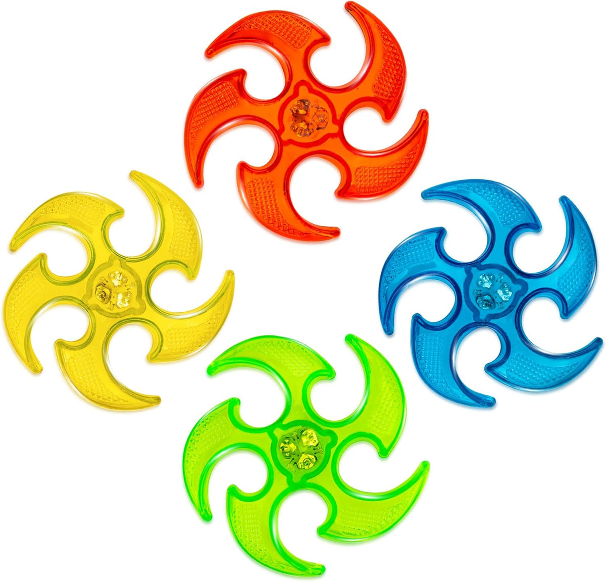 Four unlit translucent ninja flying discs in red, yellow, blue and green on a white background