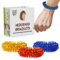 Hedgehog Bracelets box with a set of 3 yellow, orange and blue metal fidget sensory bracelets, one worn on a wrist