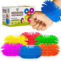 Six fuzzy fidget bracelets in bright colors with the hedgehog bracelet box and one worn on a wrist