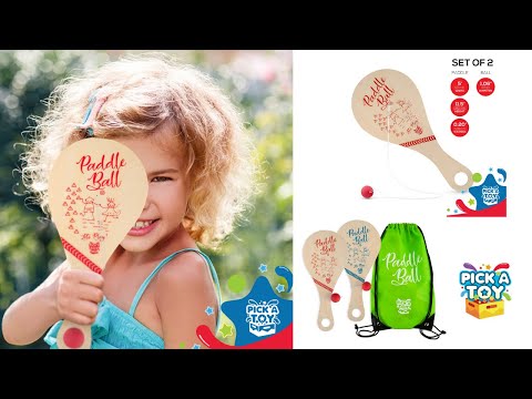 Video of a girl holding a wooden paddle ball toy, plus the set of 2 paddles with a green carry bag